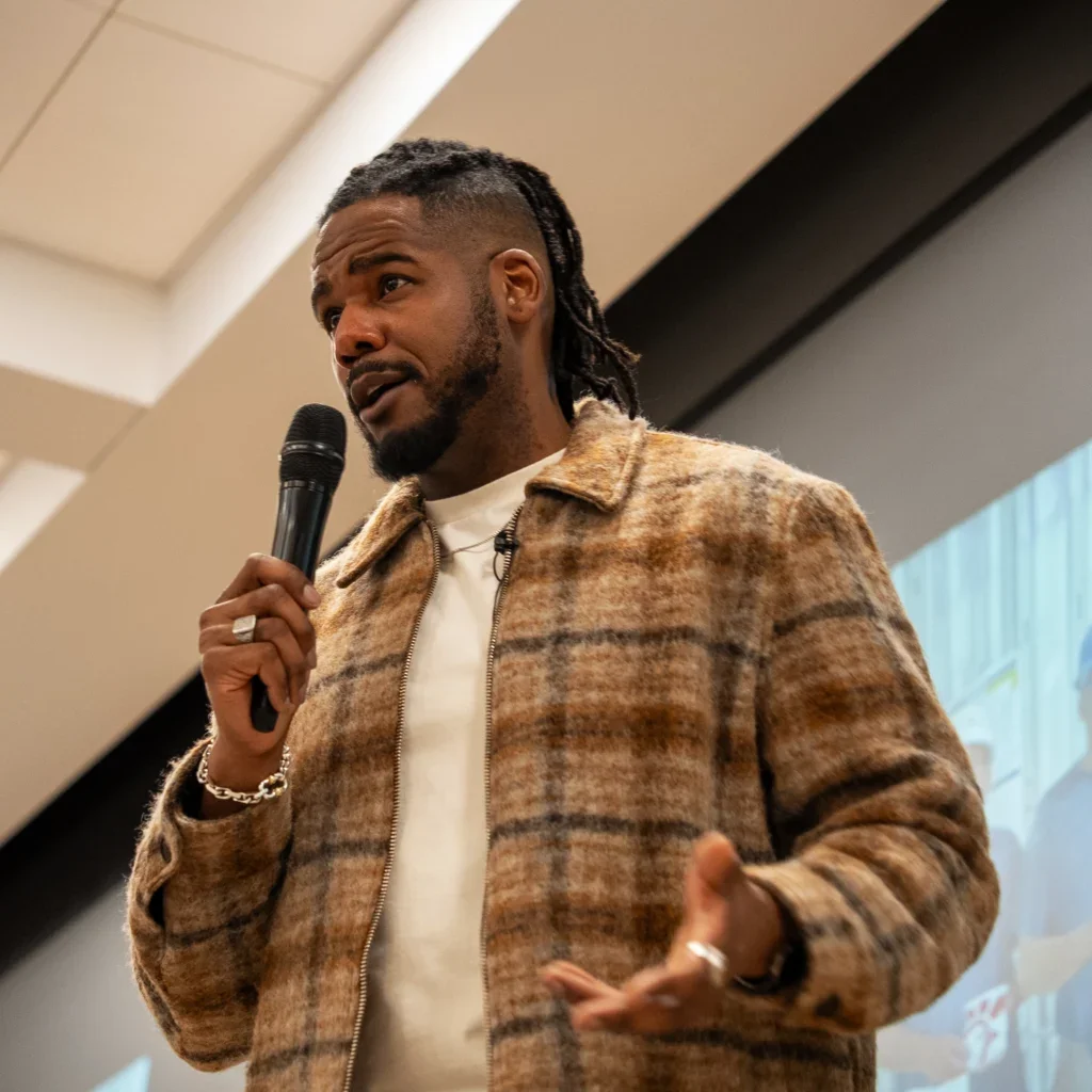 Brandon speaking in front of a large screen
