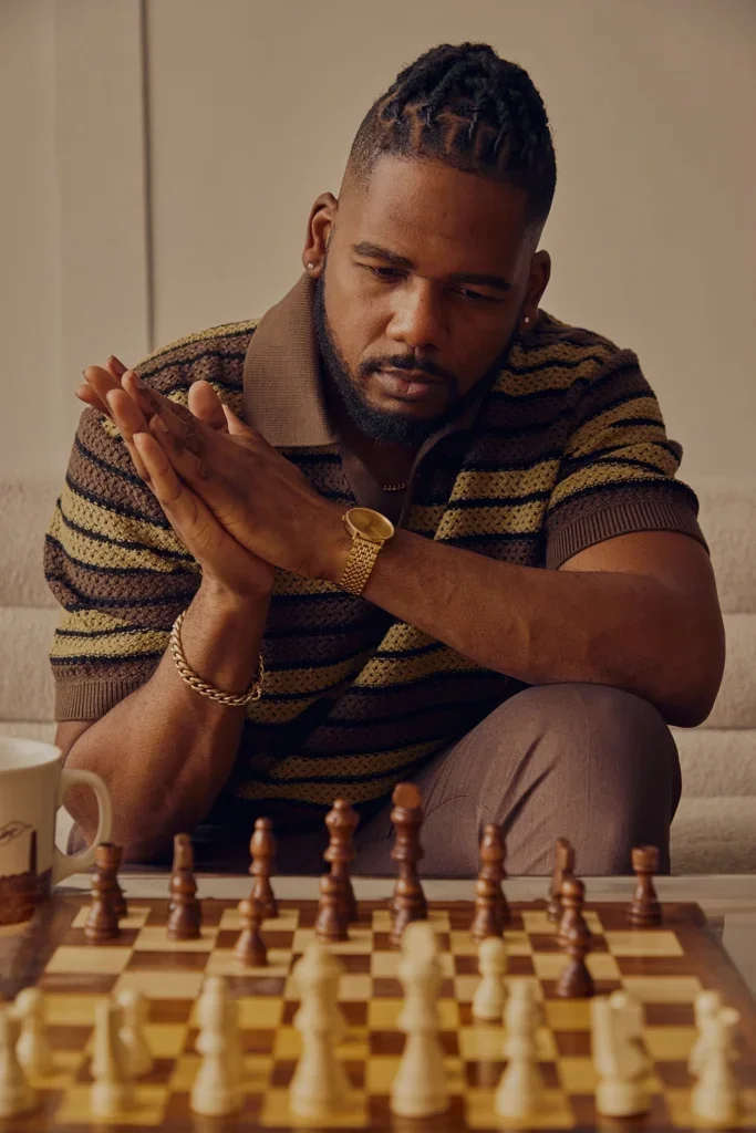 Brandon playing chess and looking contemplative