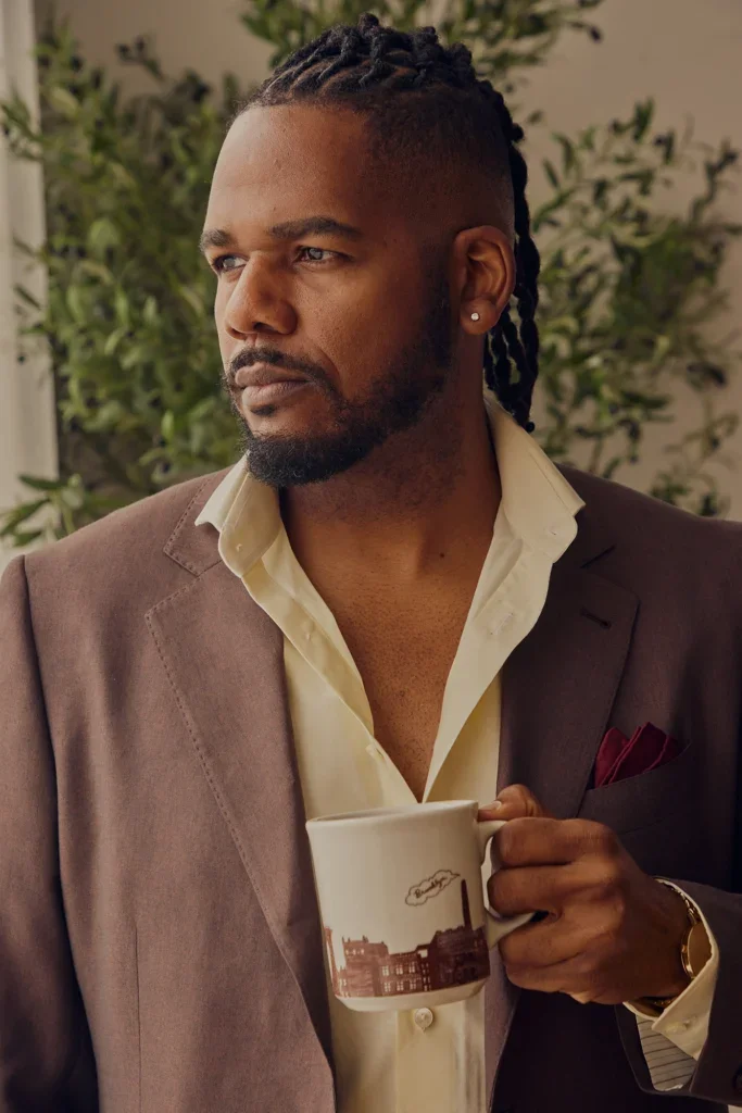 Brandon holding a coffee mug and looking to the side